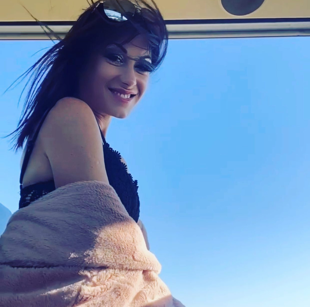 NuttaLyA smiling against a bright blue Los Angeles sky